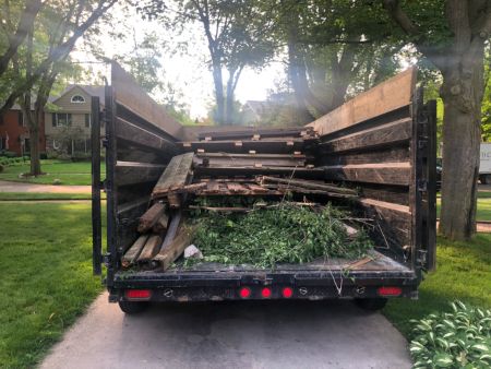  Crew loading brush and branches into a truck in Rochester, MI neighborhood